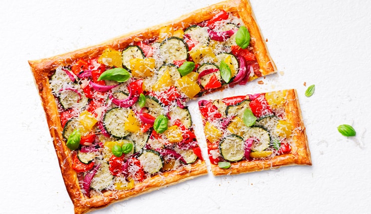 Use ready-rolled puff pastry to make this easy cheesy, veg-packed dish