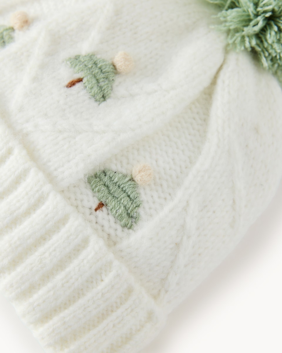 image 1 of Christmas Baby Cable Knit Tree Pom Pom Hat in Cream