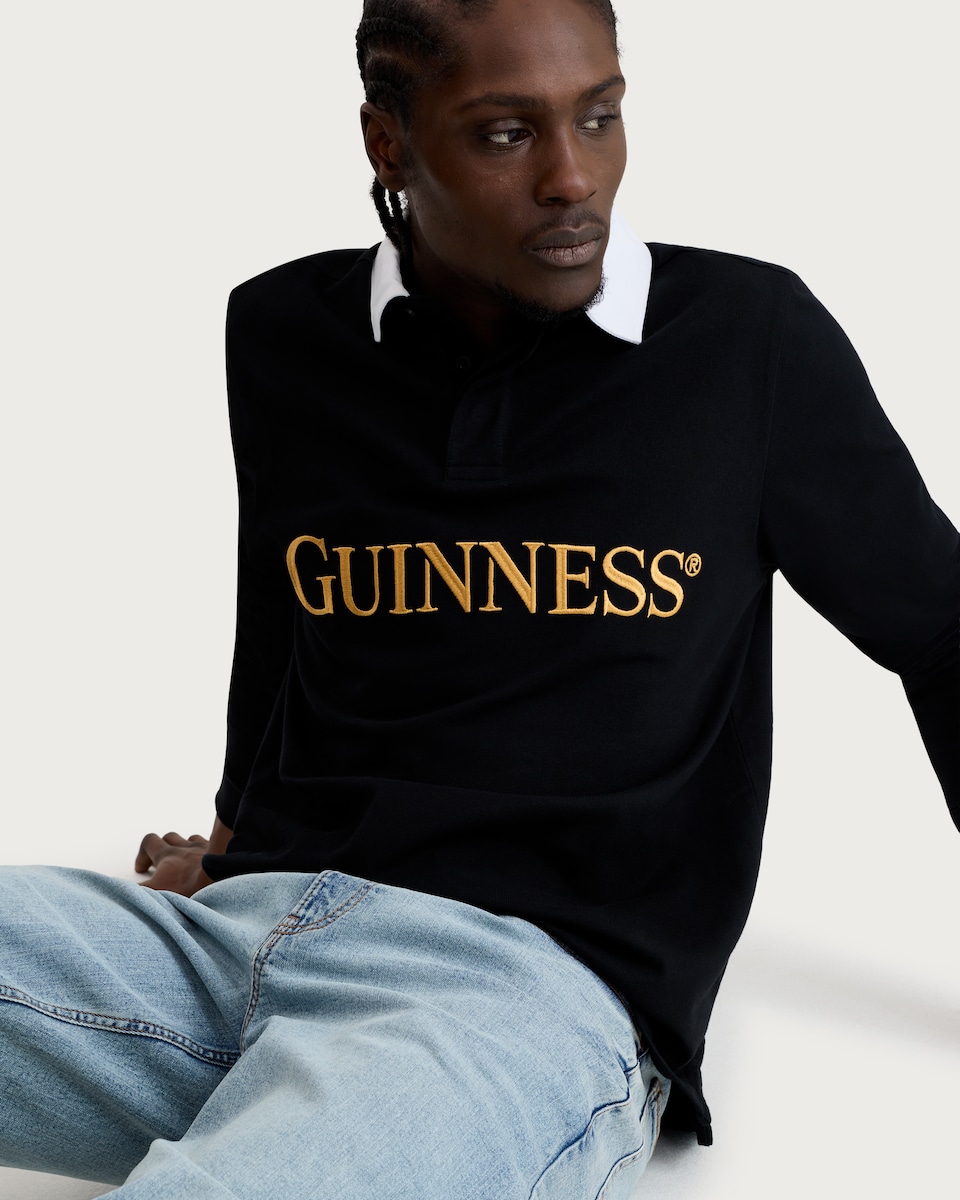 image 1 of Guinness Pure Cotton Embroidered Slogan Long Sleeved Rugby Shirt in Black