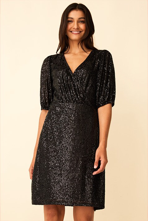 Black, knee-length, allover sequin dress with elbow-length sleeves and a wrap top.