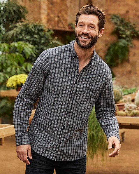 Dark blue and light blue long sleeve check shirt with small stag emblem on the chest