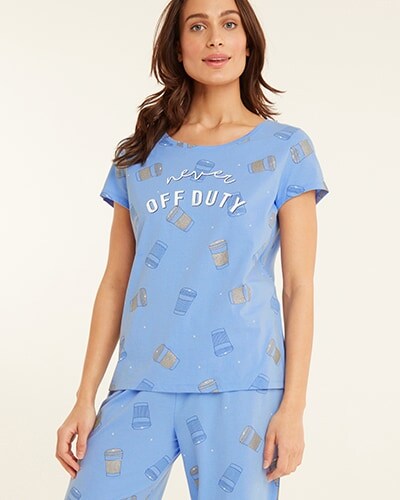 Blue short sleeve PJ top with yellow and blue coffee cup print and  'never off duty' written across the chest. Paired with matching PJ bottoms