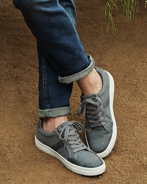  Light grey, lace-up trainers with darker grey stripe detail, and white sole