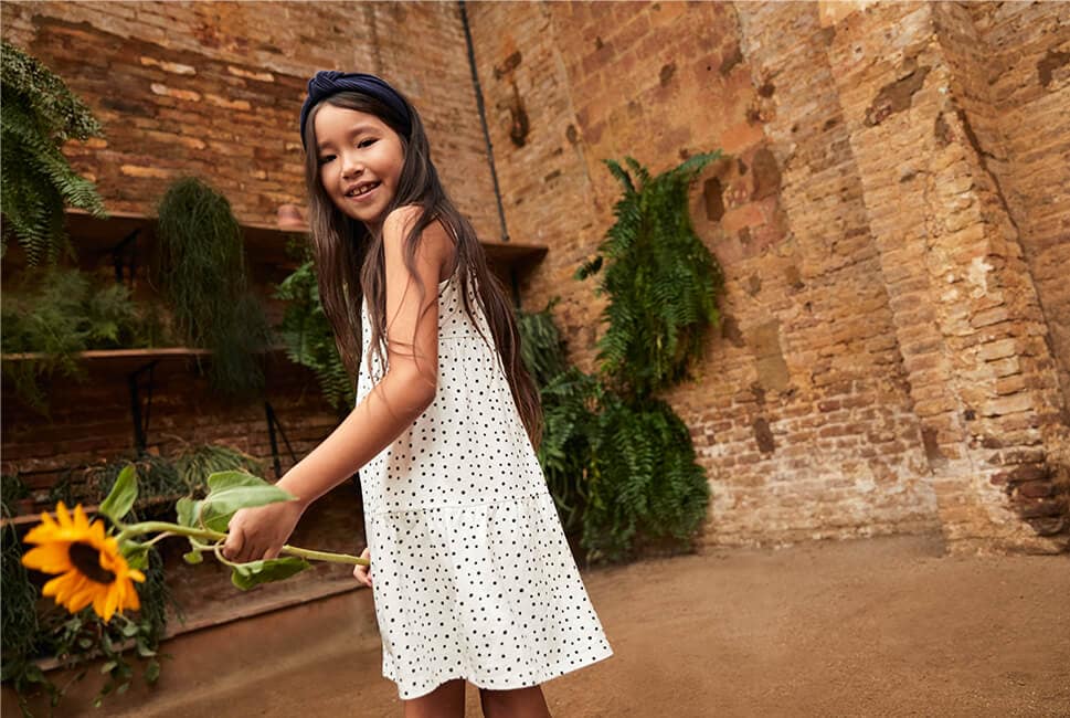 White sleeveless dress with black polka dot print