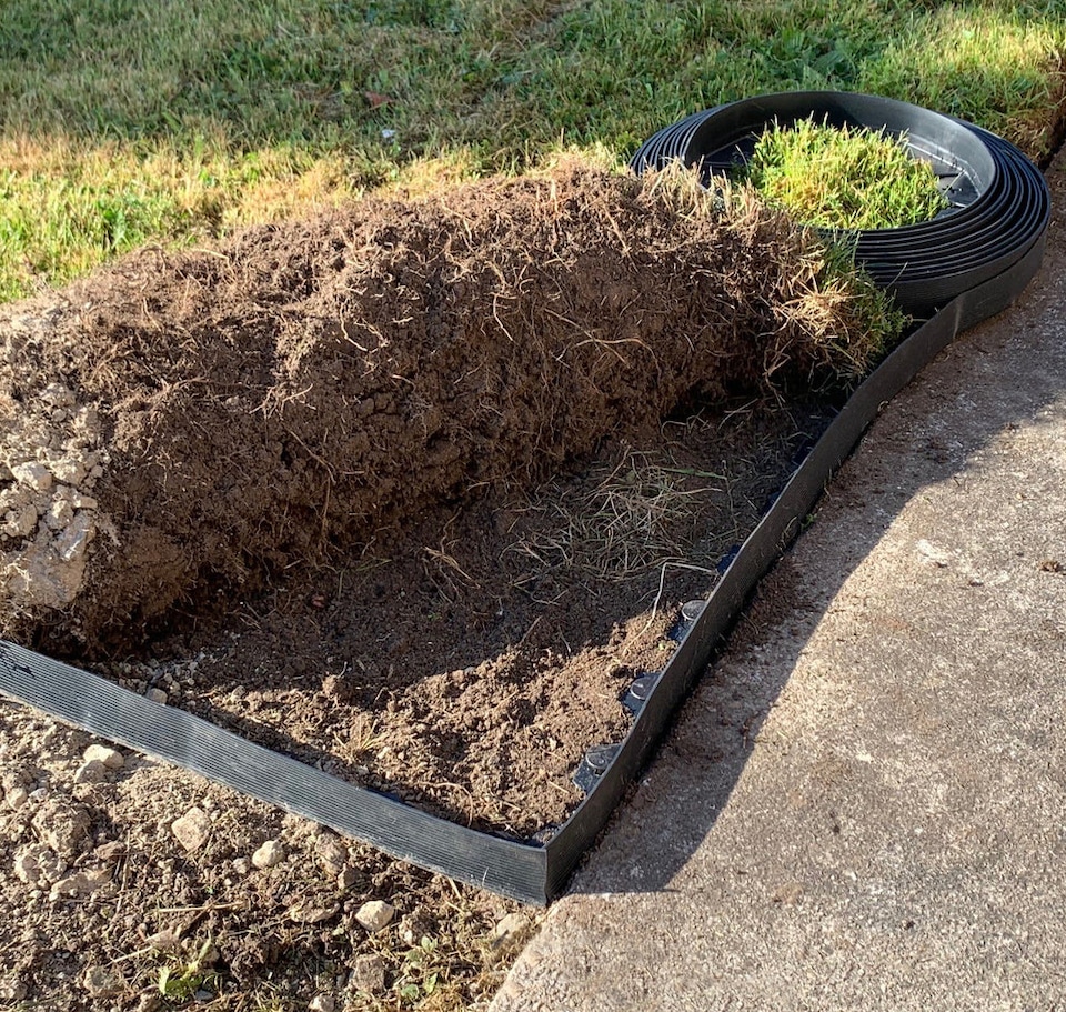 image 1 of Flexible Black Plastic Garden Lawn Edging with 40 Pegs (10m) - 4 Rolls
