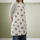 image 2 of Catherine Lansfield Angus Highland Cow Cotton Kitchen Adult Apron Natural Cream | Natural