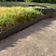 image 8 of Flexible Black Plastic Garden Lawn Edging with 40 Pegs (10m) - 3 Rolls