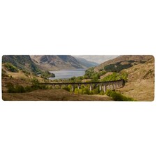 The Glenfinnan Viaduct carries the West Highland Railway Line high above Glen Finnan valley beside the lochs and mountains of Scotland Designer (Runner Rug)