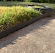 image 5 of Flexible Black Plastic Garden Lawn Edging with 40 Pegs (10m) - 4 Rolls