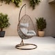 image 1 of Interiors by Premier Luxurious Brown Rattan Hanging Chair, Versatile Lounge Chair, Sturdy Bedroom Chair, Modern Garden Chair
