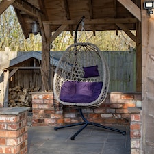 Samuel Alexander Hanging Garden Rattan Egg Chair with Steel Frame and Waterproof Cover in Indigo | Purple | Indigo