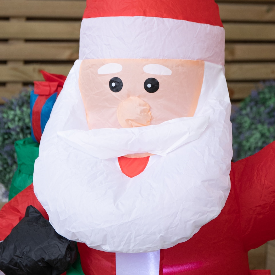 image 1 of 130cm (4ft) Inflatable LED Outdoor Christmas Standing Santa with Gift in Sack