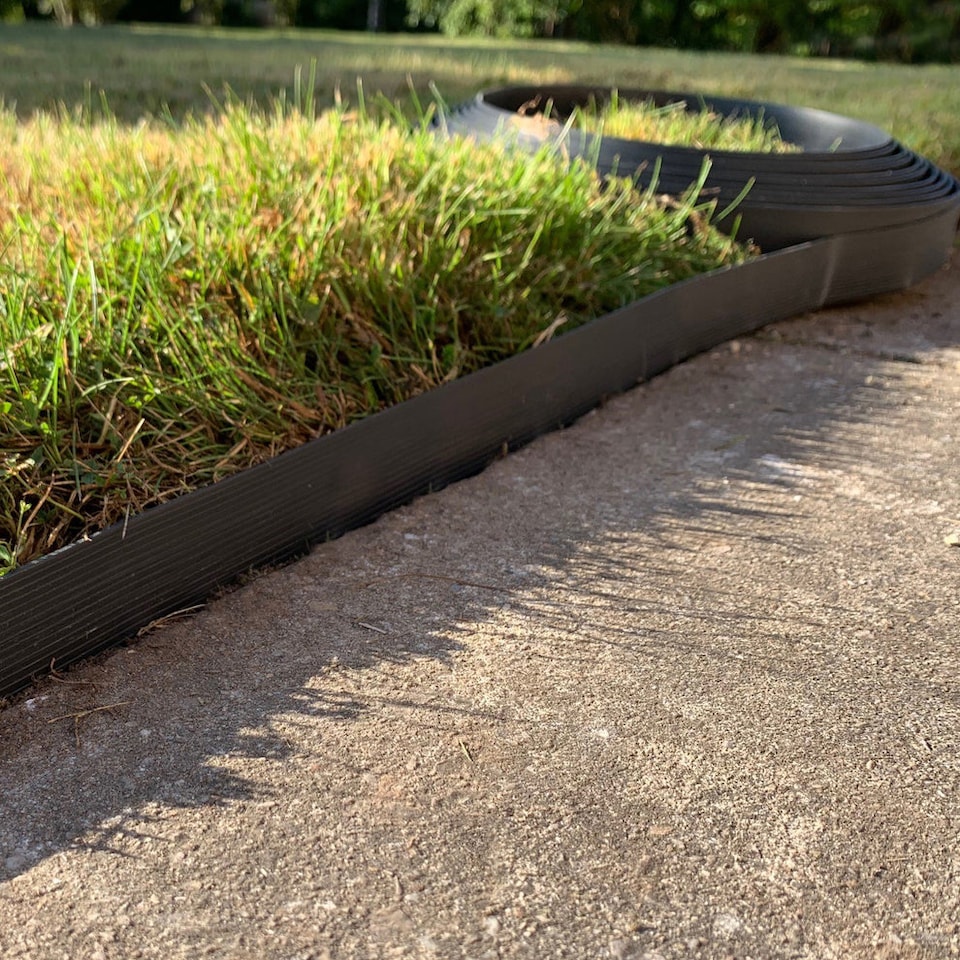 image 1 of Flexible Black Plastic Garden Lawn Edging Roll with 40 Pegs (10m)