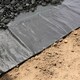 image 6 of Harbour Housewares 110gsm Weed Control Membrane Set with Pegs & Plates - 2m x 5m (1 Roll) - Weed Fabric Garden Membrane Weed Membrane Flower Bed Membrane Black