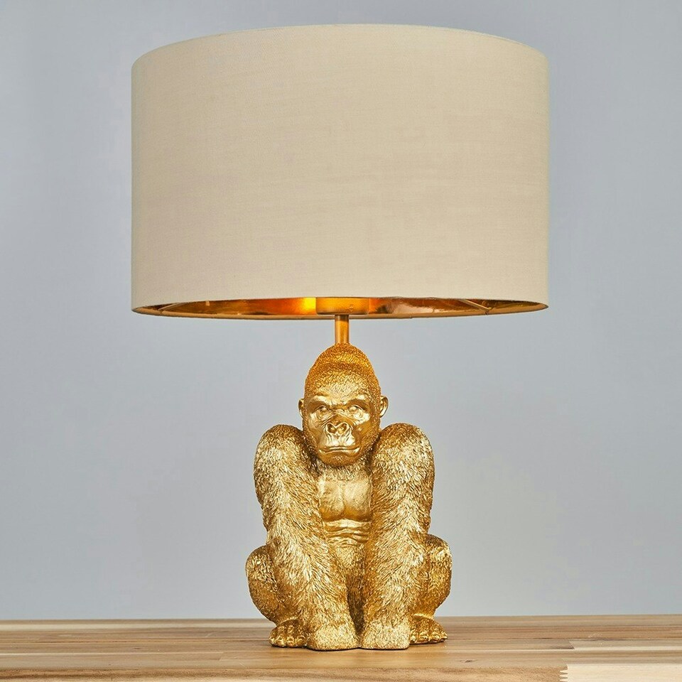 image 1 of ValueLights Gus Modern Gold Sitting Gorilla Monkey Design Table Lamp with Beige Gold Cylinder Shade