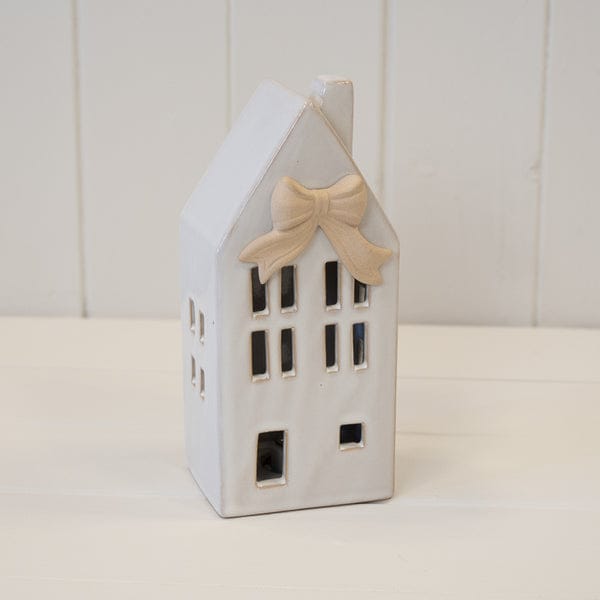 Four Candle Medium Ceramic LED House with Bow Details in Natural