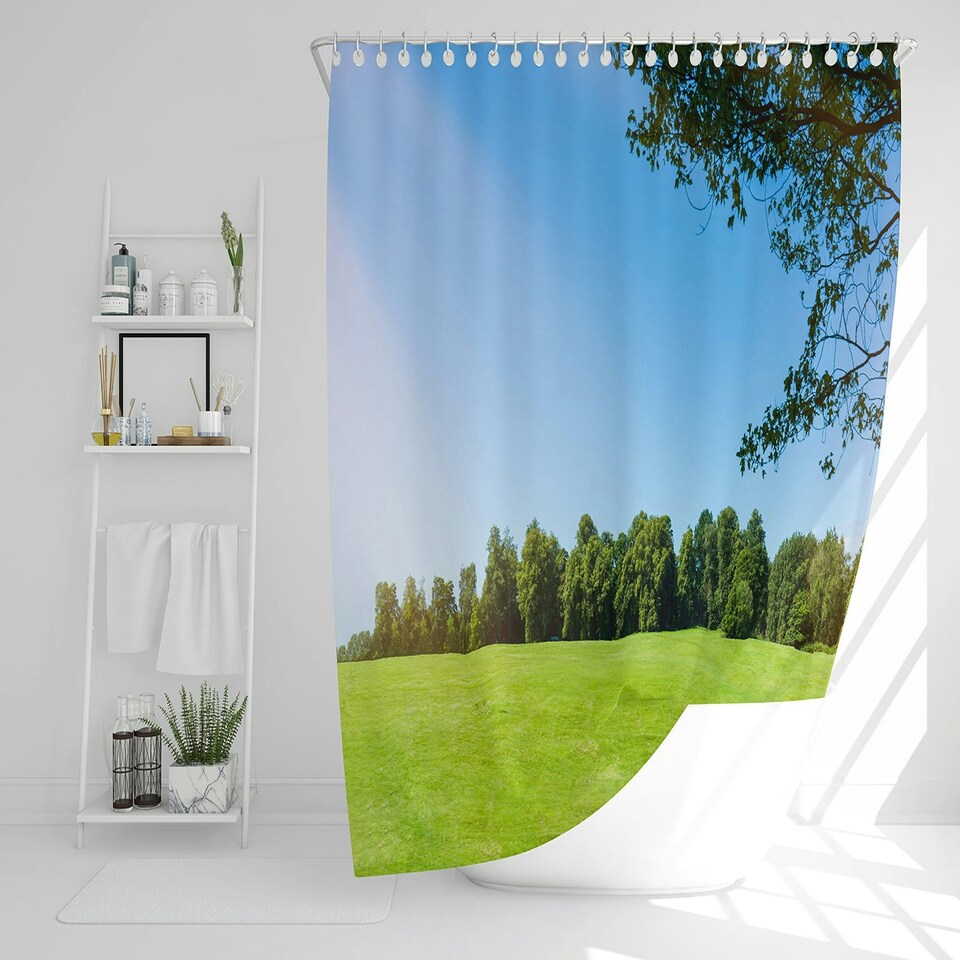 image 1 of Beauty landscape of grass field with forest trees and environment public park with sun rays (Shower Curtain)