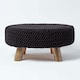 image 1 of Homescapes Black Large Round Cotton Knitted Footstool on Legs | Black | 62 x 62 x 30 cm