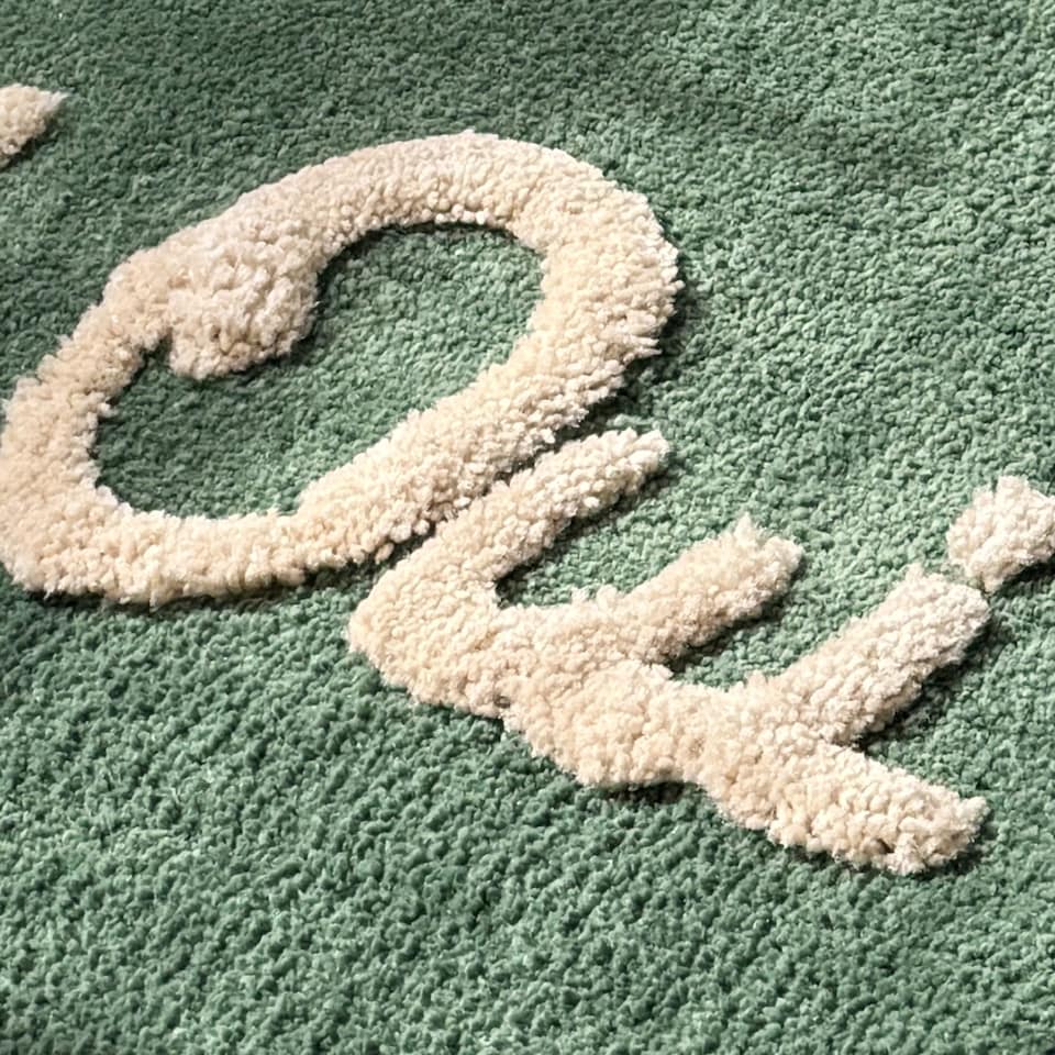 image 1 of Oui Oui Slogan Scalloped Bath Mat