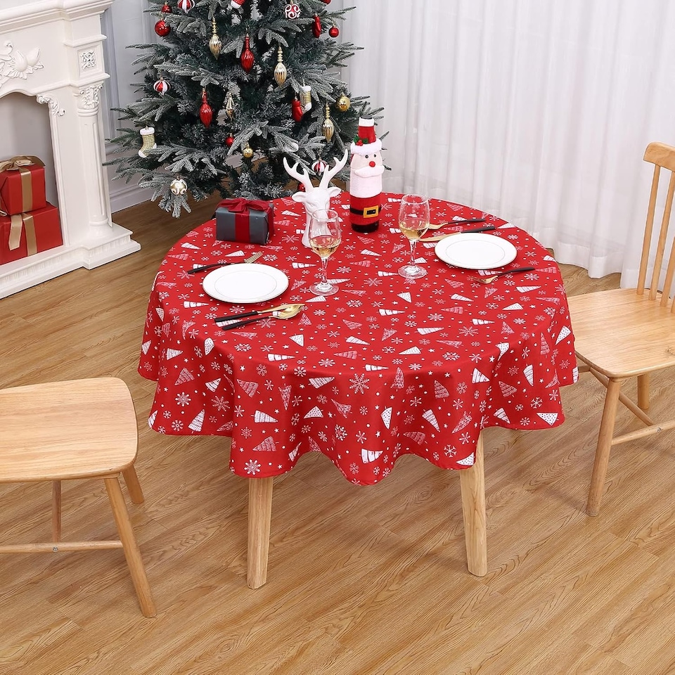 image 1 of London Boutique Round Christmas Tablecloth, Waterproof Wipe‑Clean, Snowflake and Tree Print, Red, 60 in