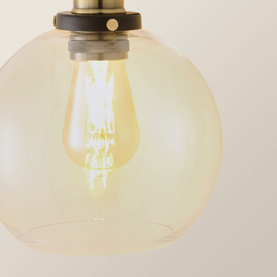 image 1 of ValueLights Sheridan Black and Gold Wall Light Amber Glass Shade
