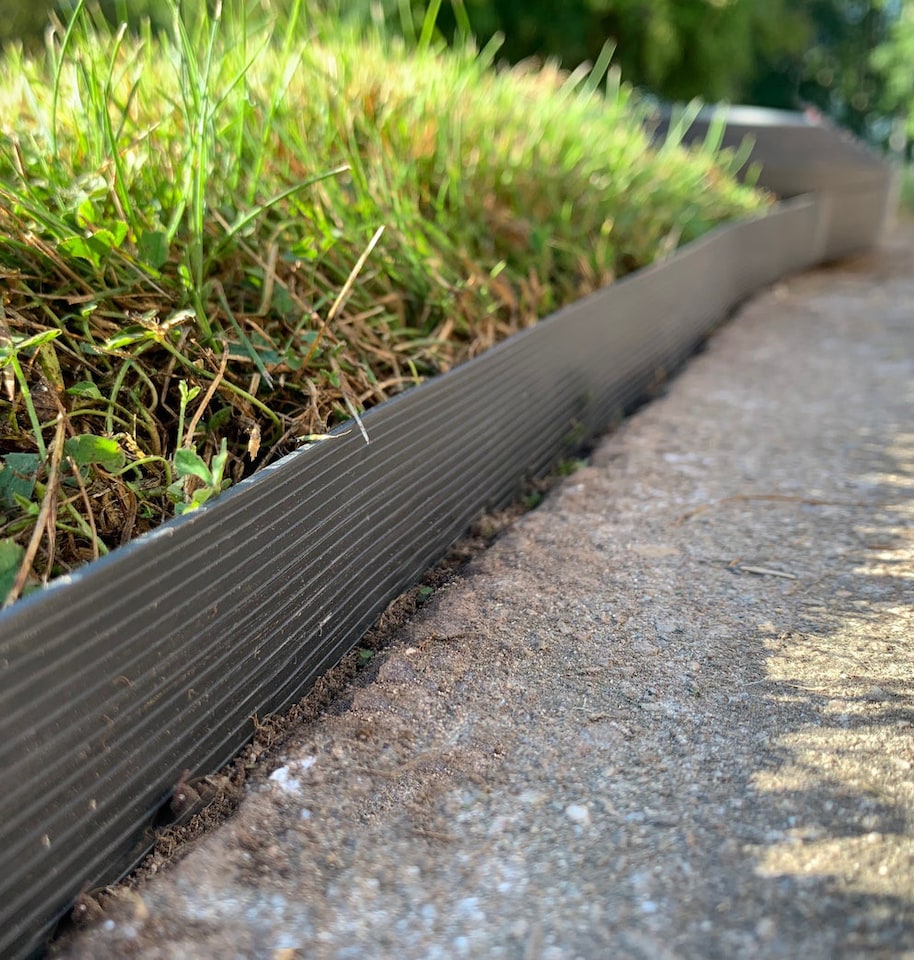 image 1 of Flexible Black Plastic Garden Lawn Edging with 40 Pegs (10m) - 4 Rolls