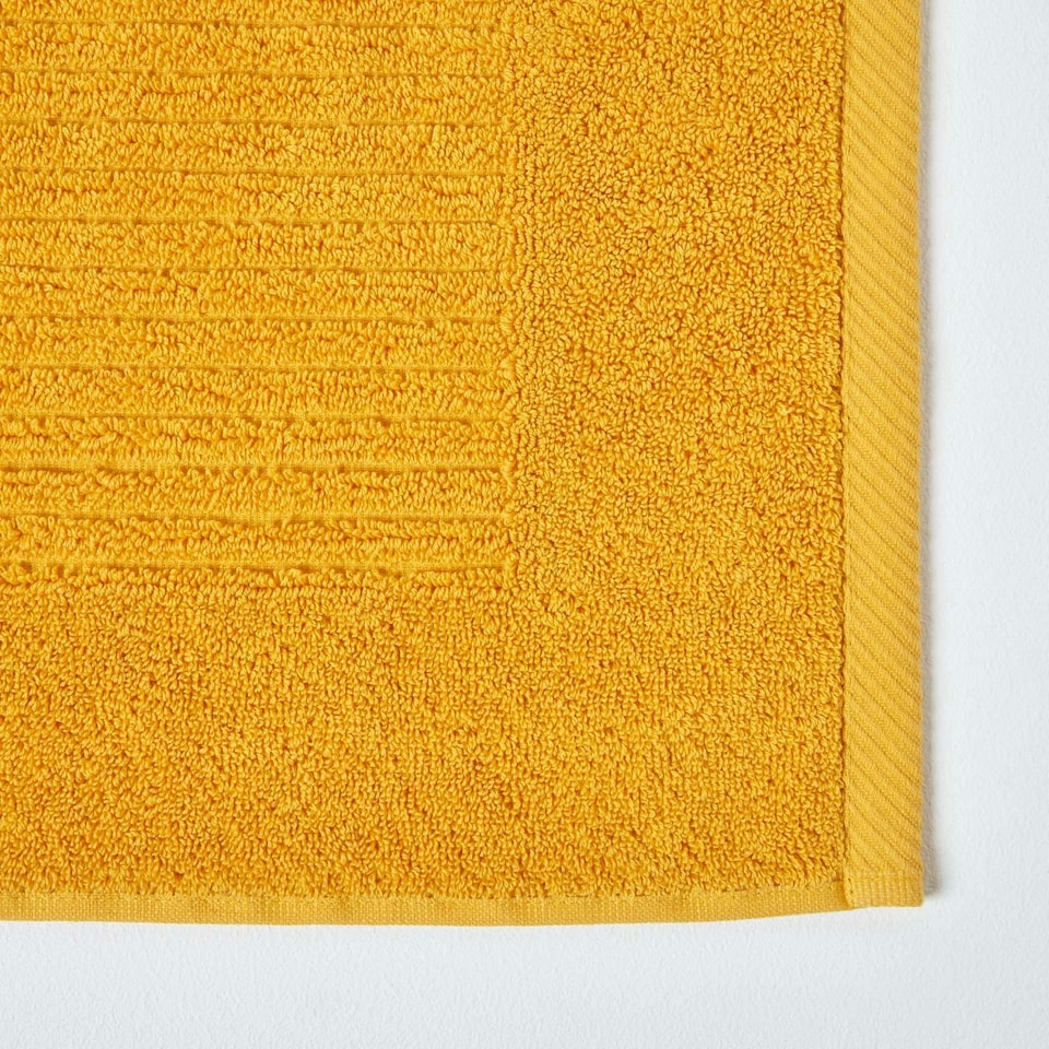 image 1 of Homescapes Imperial Plain Cotton Ochre Yellow Bath Mat Yellow