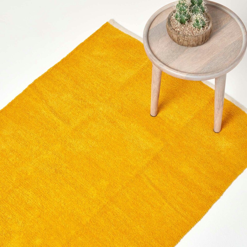 image 1 of Homescapes Mustard Cotton Plain Chenille Rug with Natural Trim - 60 x 100 cm | Yellow | Mustard
