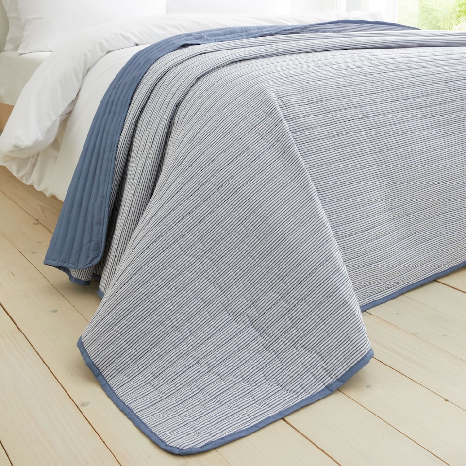 image 1 of Catherine Lansfield Stripe Quilted Reversible Bedspread | Blue | One Size