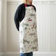 image 2 of Catherine Lansfield Christmas Town Cotton Kitchen Adult Apron Natural Cream | Natural