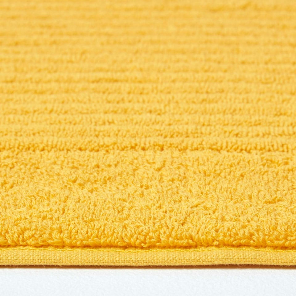 image 1 of Homescapes Imperial Plain Cotton Ochre Yellow Bath Mat Yellow
