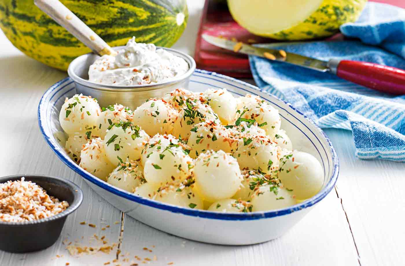 Melon ball salad with vanilla mint syrup and toasted coconut cream