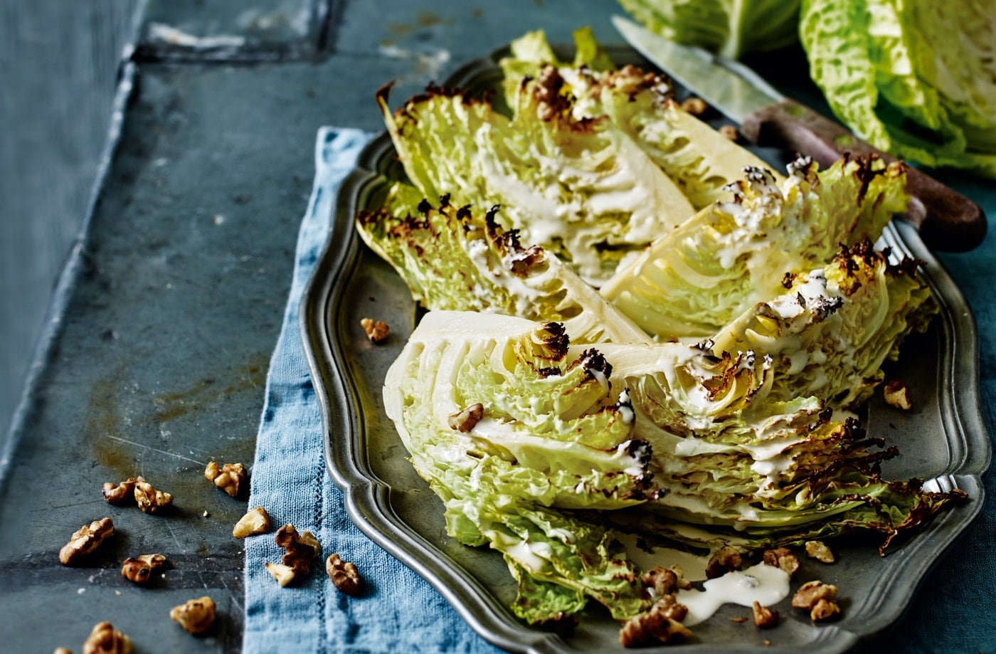Roasted Savoy cabbage wedges with blue cheese dressing and walnuts