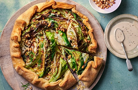 Image of "Charred cabbage galette with roasted garlic and tahini"