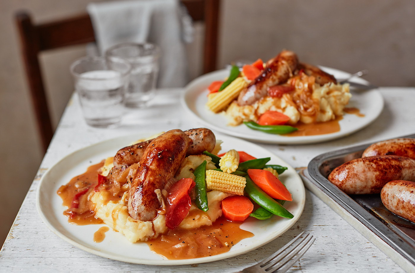 Sausage and cheesy mash with tomato gravy
