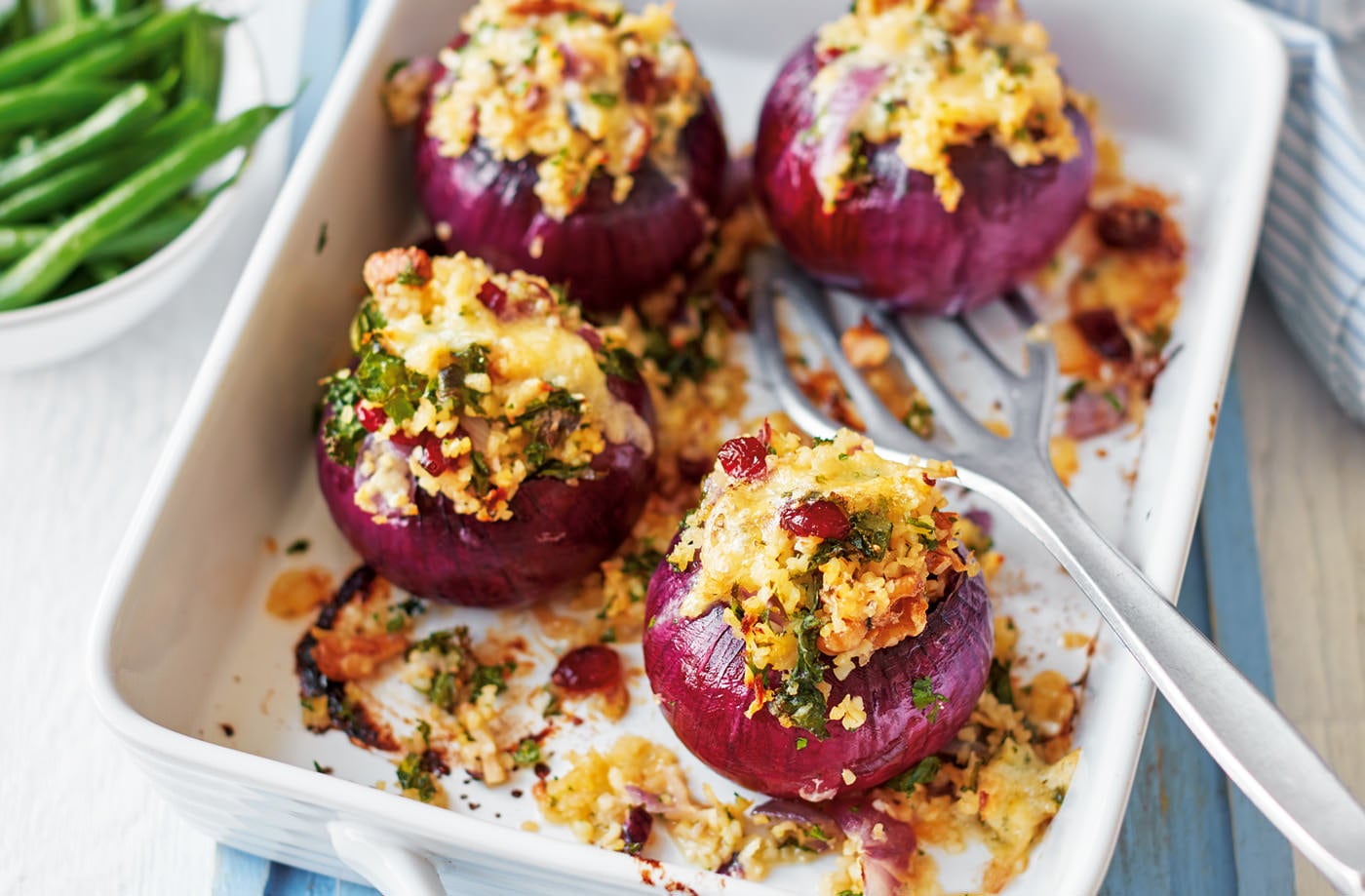 Red onions stuffed with bulgur wheat, celeriac and kale
