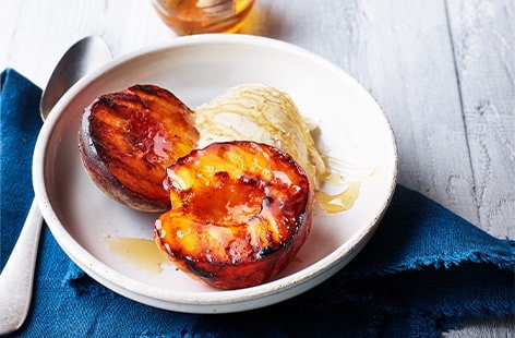 Image of "Honey-glazed peaches with vanilla ice cream"