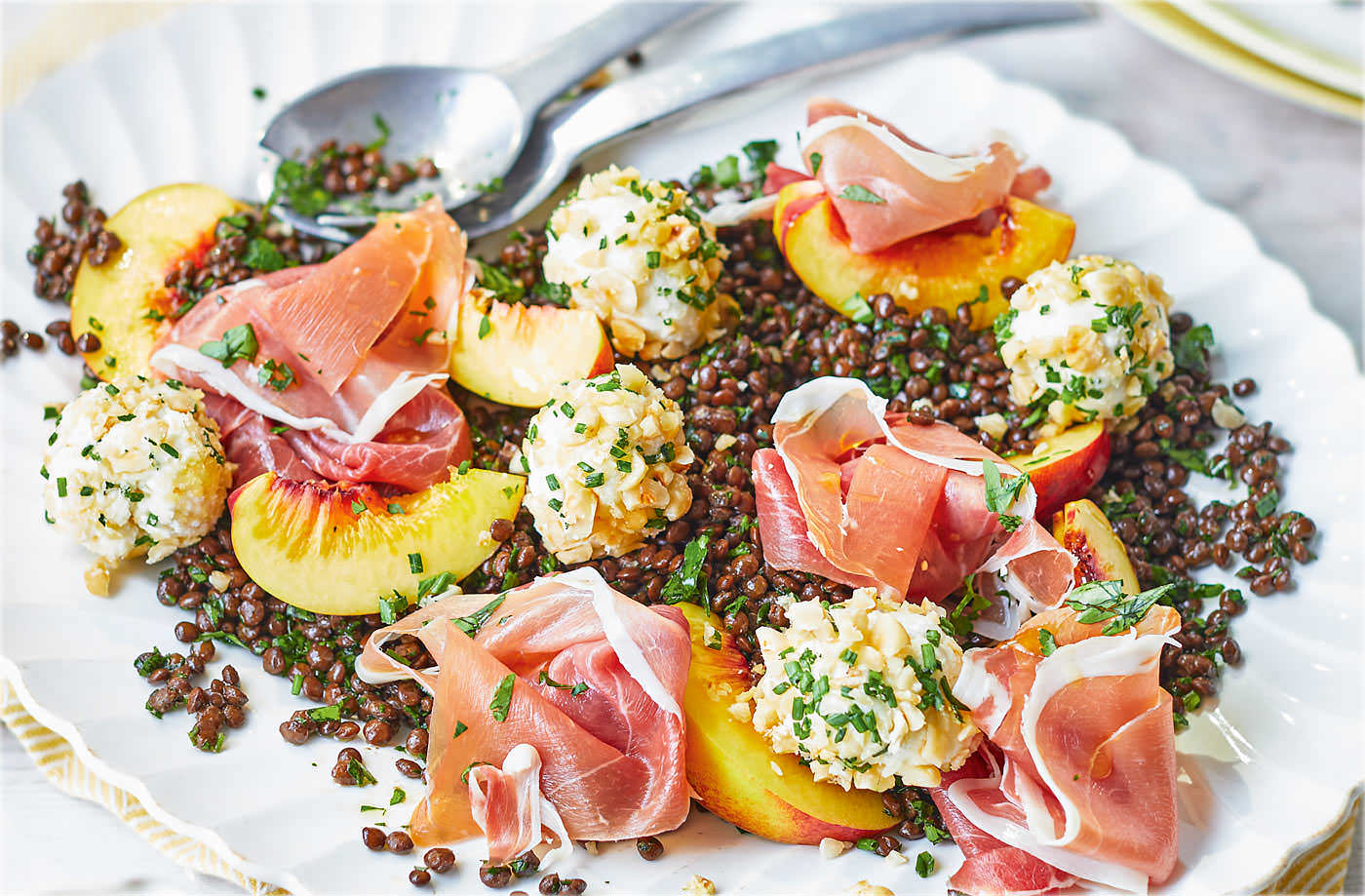 Puy lentil salad with cheese balls, Parma ham and peach
