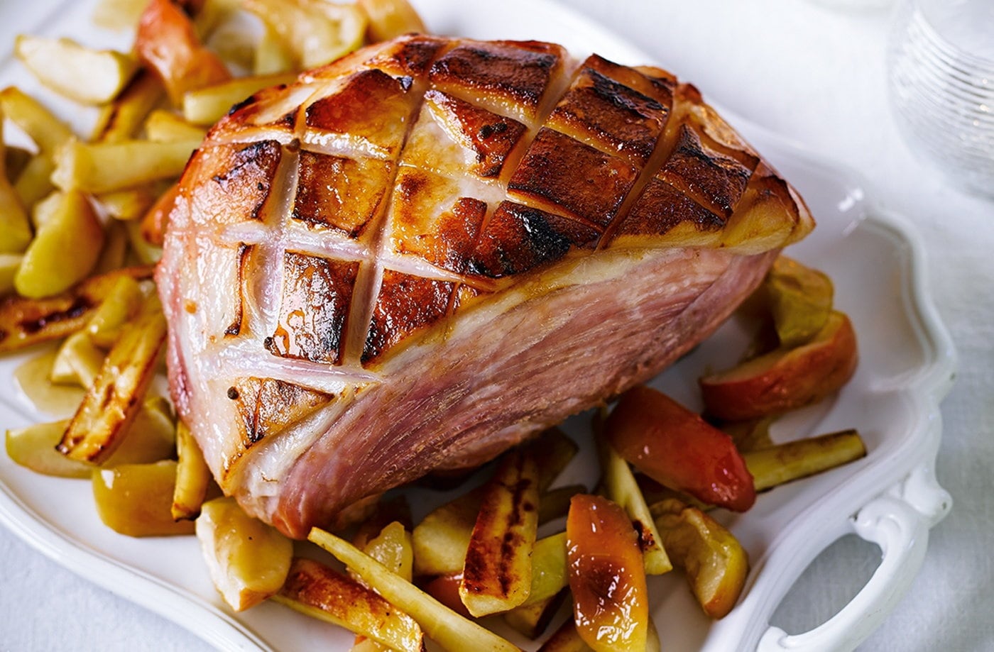 Calvados and honey glazed ham with baked apples and parsnips