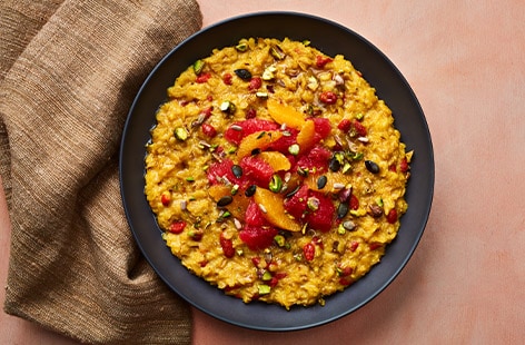 Golden milk porridge with fruit and seeds