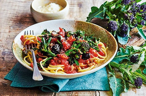 Image of "Spaghetti with purple sprouting broccoli and tomato and olive sauce"