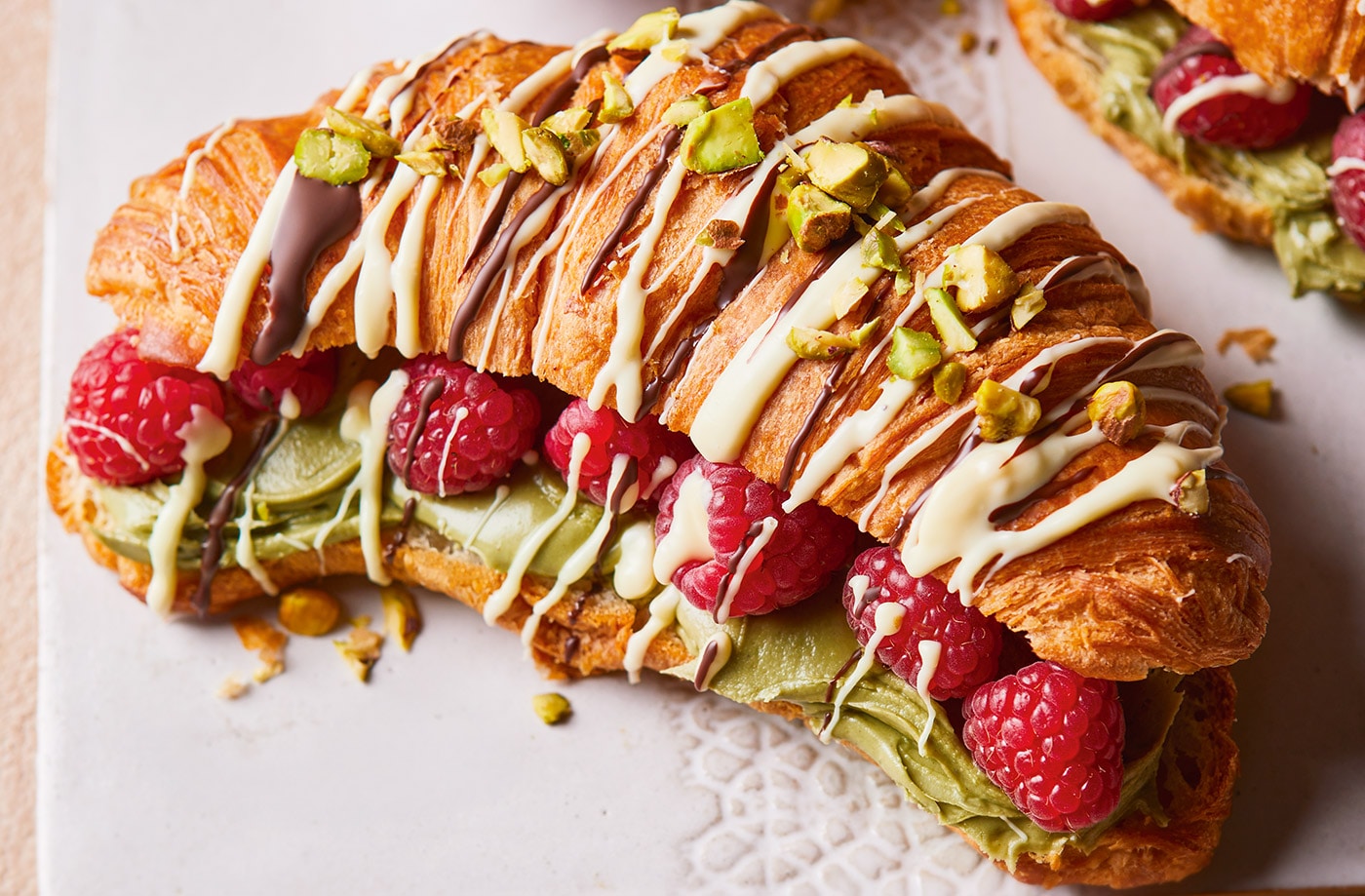 Drizzled croissants with pistachios and raspberries