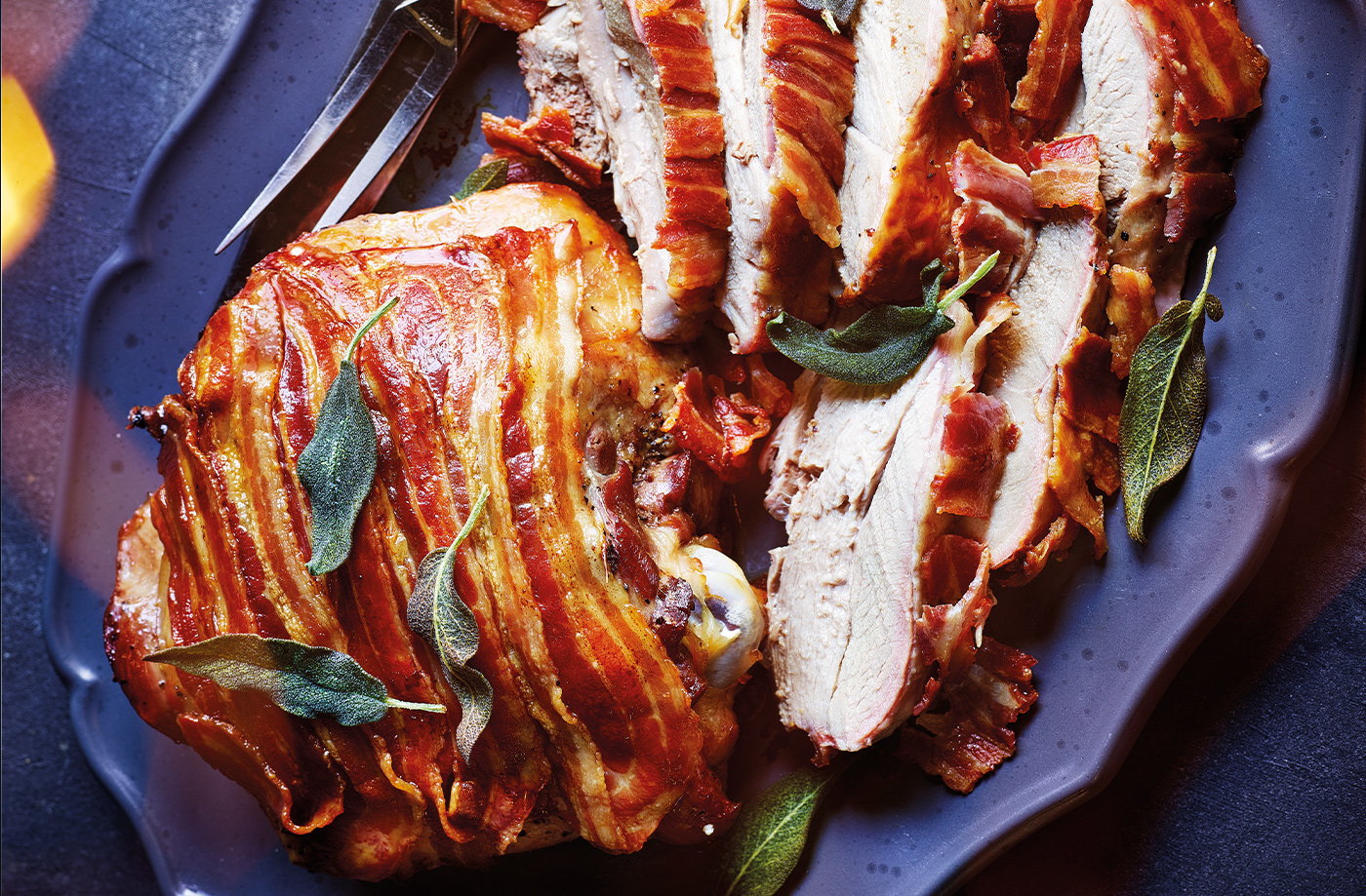 Brined turkey thighs wrapped in bacon with crispy sage