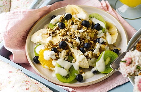 Image of "Fruit salad plate with yogurt and granola"