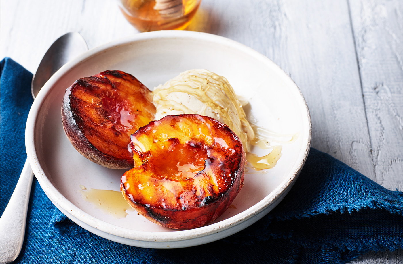Honey-glazed peaches with vanilla ice cream