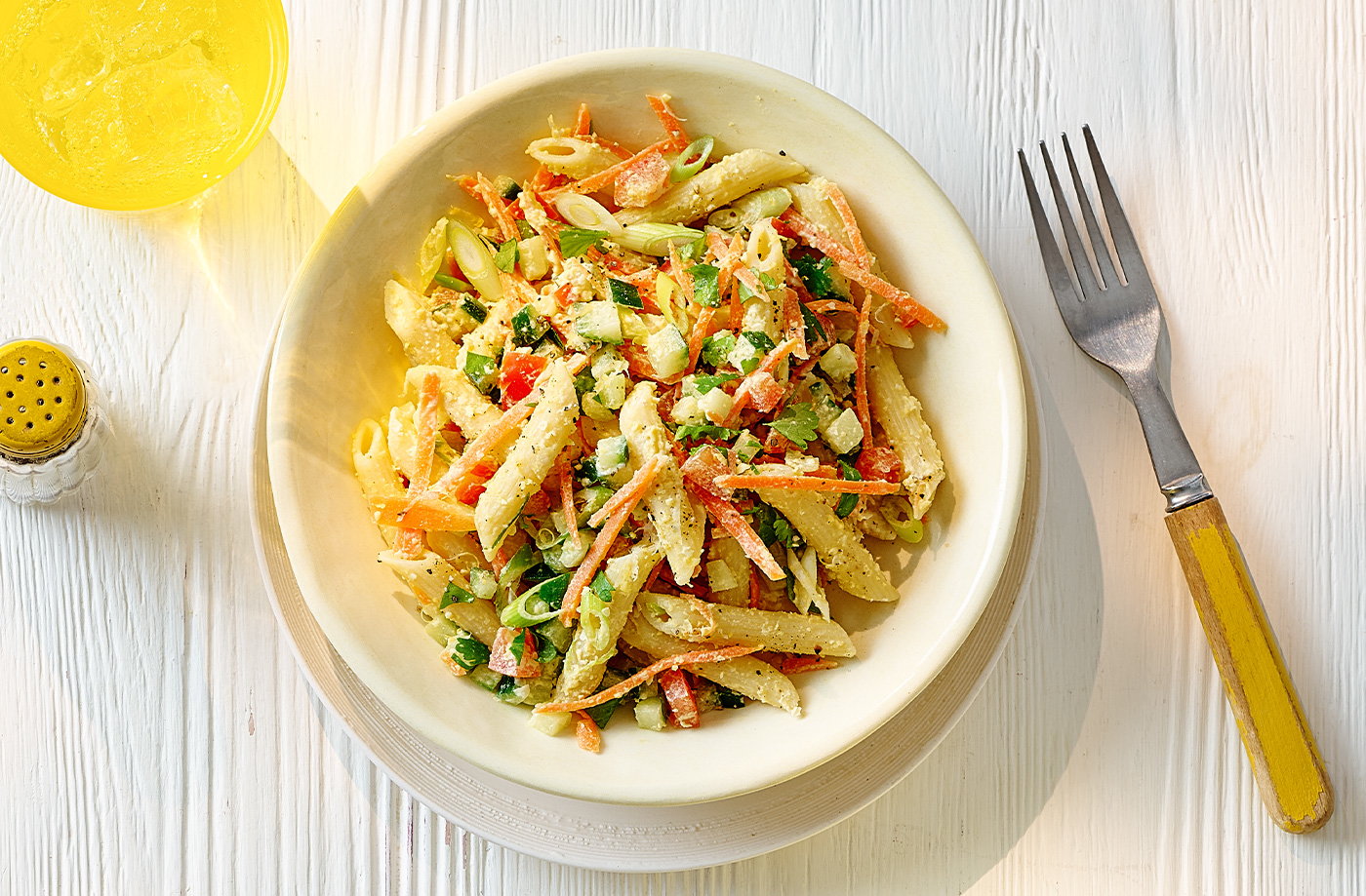 Houmous pasta salad with cucumber, tomatoes and carrots