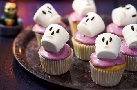 Image of "Spooky blackberry cupcakes with marshmallow skulls"