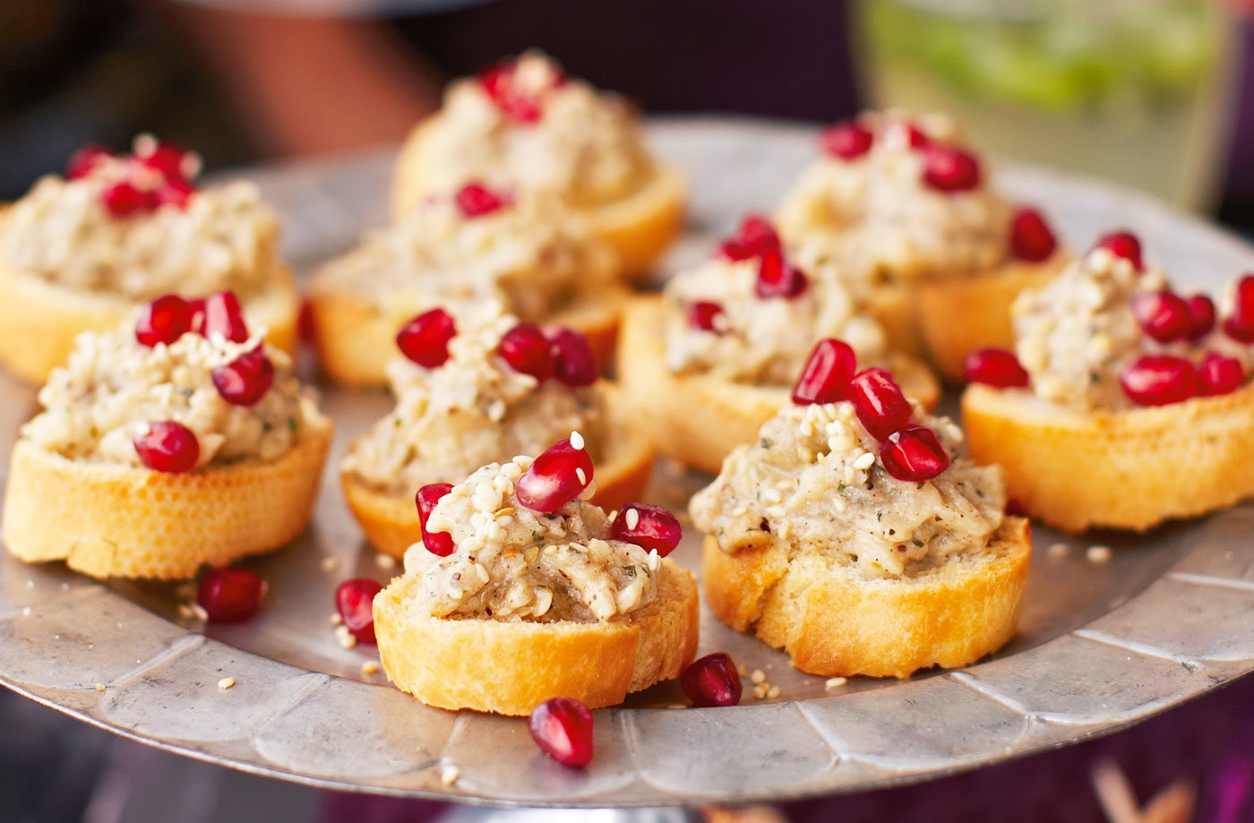 Smoked aubergine caviar crostinis with sesame and pomegranate