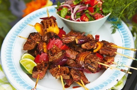 Image of "Brazilian-style barbecue beef skewers with tomato salad"