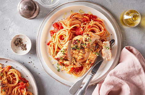 Image of "Olive oil and herb marinated chicken with tomato spaghetti"